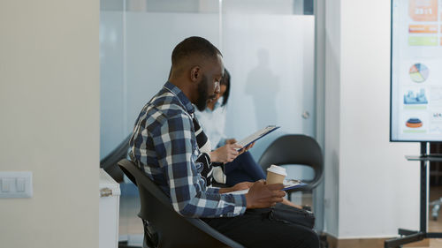 Side view of man working at office