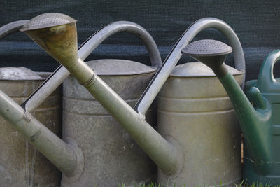 High angle view of pipe on metal fence
