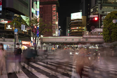 People crossing the shibuya crossing by night, long exposure