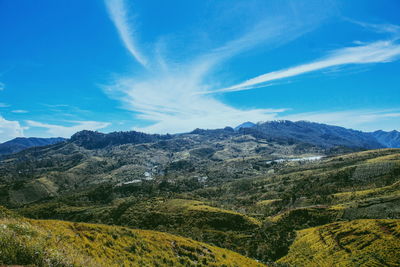 Scenic view of dramatic landscape against blue sky
