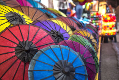 Colorful handmade paper umbrellas at traditional street night market in luang prabang, laos.