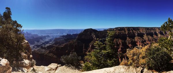 Panoramic view of landscape against clear blue sky