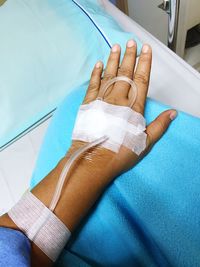 Cropped image of woman hand with iv drip at hospital