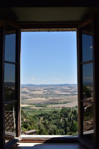 Scenic view of landscape seen through window