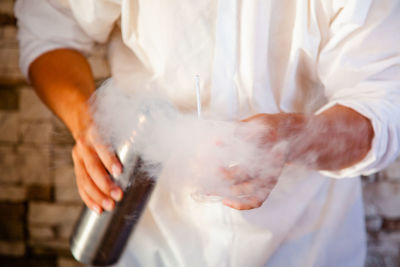 Midsection of man working in kitchen