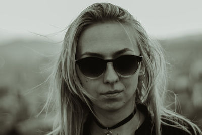 Portrait of woman wearing sunglasses against sky