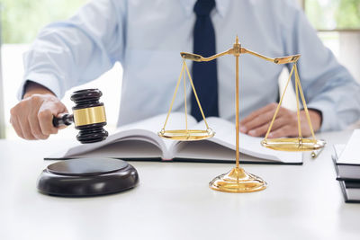 Close-up of man holding umbrella on table