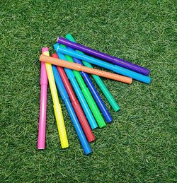 High angle view of colored pencils on field