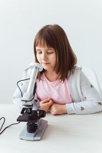 Portrait of girl looking down on table