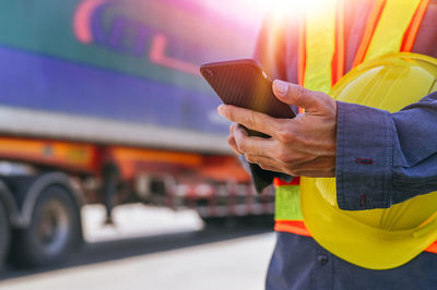 Cropped hand of man using mobile phone