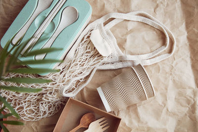 Natural, eco-friendly, plastic free, zero waste tableware. eco shopping bag on crumpled paper. 