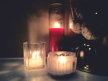 Lit tea light candles on table