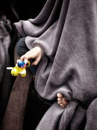 Midsection of woman holding toy