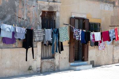 Clothes drying on clothesline outside building
