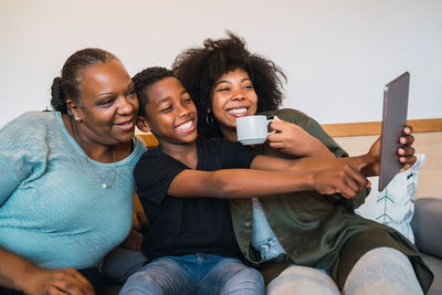 Cheerful family taking selfie at home