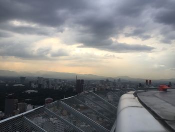 Cityscape against cloudy sky