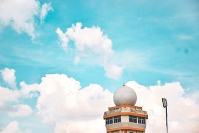 Low angle view of building against cloudy sky