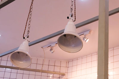 Low angle view of light bulbs hanging from ceiling
