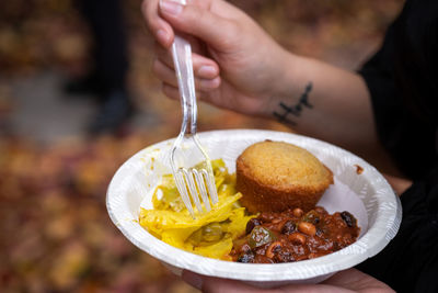 Close-up of person eating warm bowl of food