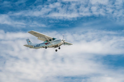 Low angle view of airplane flying against sky