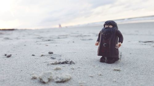 Rear view of woman standing on beach