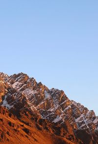 Low angle view of mountain against clear blue sky