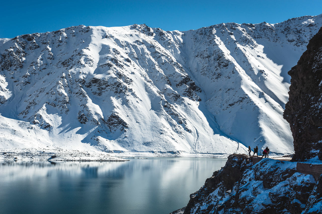 cold temperature, winter, snow, mountain, scenics - nature, beauty in nature, tranquil scene, tranquility, sky, snowcapped mountain, water, mountain range, day, nature, non-urban scene, idyllic, white color, clear sky, outdoors