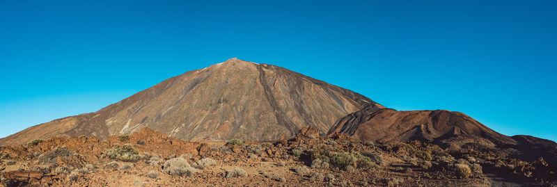 View of volcanic mountain against blue sky