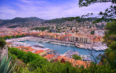 High angle view of townscape by river against sky