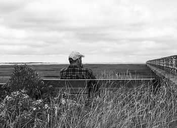 Woman standing by sea against sky