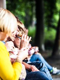 Rear view of people sitting outdoors