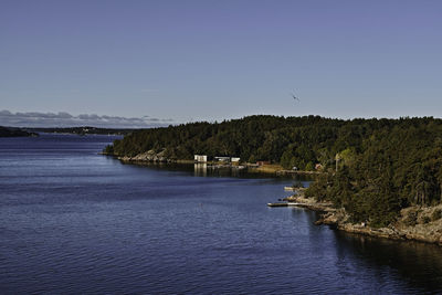 Scenic view of river against clear blue sky