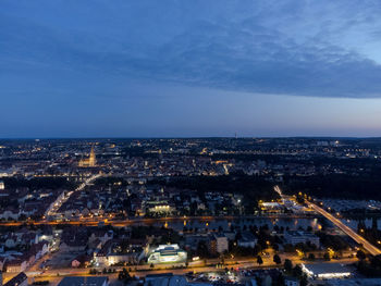 High angle view of city lit up at night