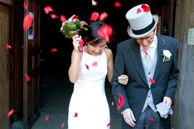 Young woman with umbrella and flowers at home