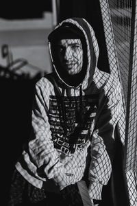 Portrait of man sitting with umbrella