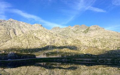 Scenic view of mountains against blue sky