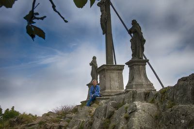 Low angle view of statue against cloudy sky