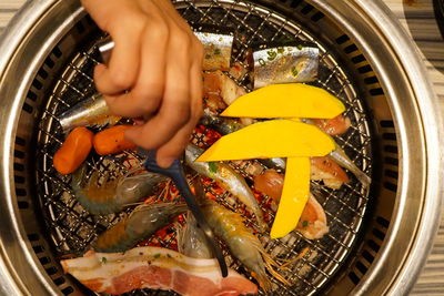 Midsection of person preparing food in kitchen