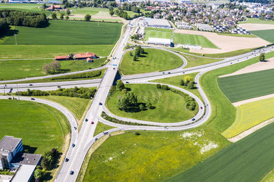 High angle view of road amidst field in city