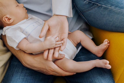 Low section of doctor examining patient at home