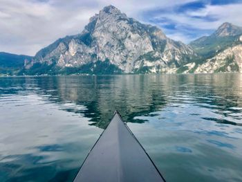 Scenic view of lake by snowcapped mountains against sky