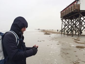 Man on beach against sky