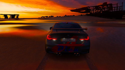 Vintage car on sea against sky during sunset