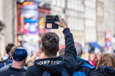 Rear view of people photographing