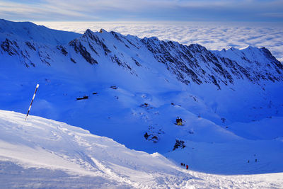 Low angle view of snowcapped mountains against sky