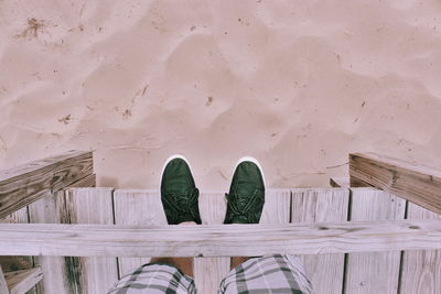 Low section of man standing on pier