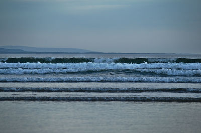 Scenic view of sea waves against sky