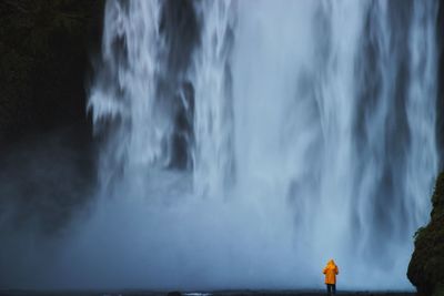 Scenic view of waterfall against sky