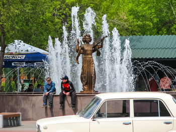 People standing by fountain