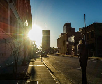 Sun shining through buildings in city